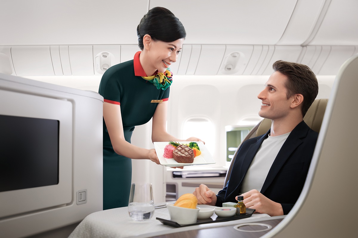 Passenger drinking wine in Royal Laurel class