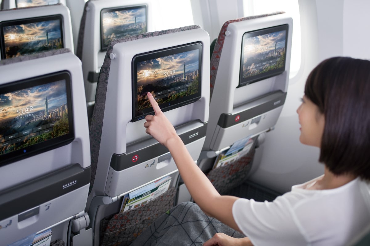 Passenger using inflight entertainment service in Economy Class
